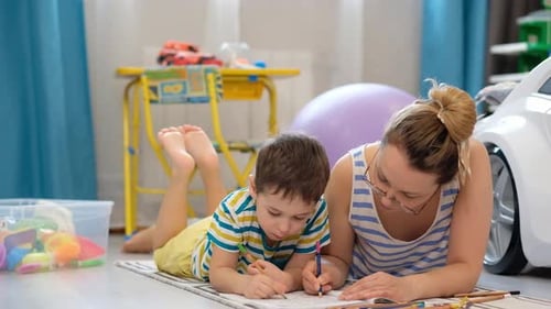 Woman and Child Drawing Together at Home