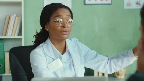 Beautiful Woman Doctor Consults Her Patient in the Hospital Using Chest Xray Scan Explaining Side