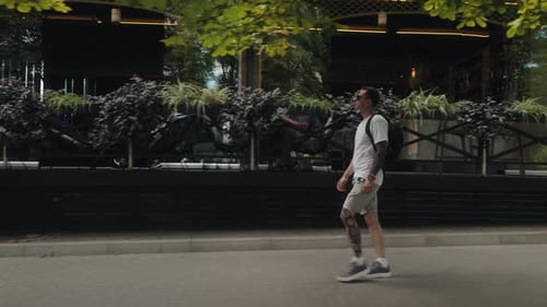 Man Walking Down City Street