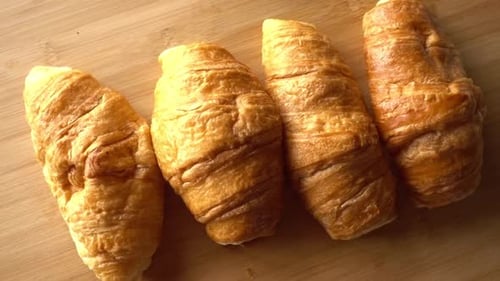 Delicious Golden Brown Croissants on Wooden Table