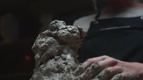 A Young Potter Girl Creates a Sculpture in the Studio Workshop with Her Hands A Female Figure Made