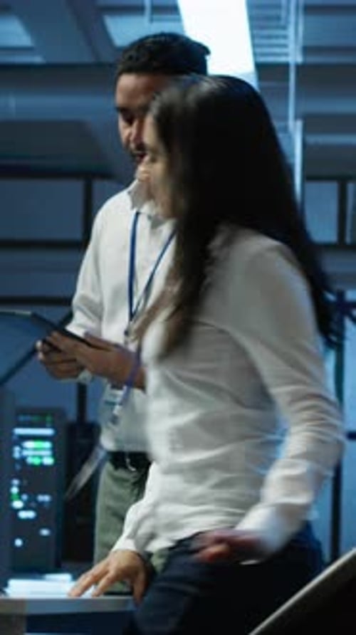 Vertical Video Team of Programmers in High Tech Data Center Troubleshooting Issues