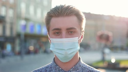 Close Up of Young Caucasian Man Wearing Medical Mask on Face and Looking at Camera Beautiful Male