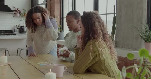 Females Friends Reading Tarot card on Kitchen table with Fortune Teller