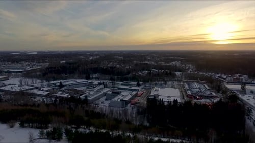 A slow leftward travelling wide aerial drone shot of a bustling city on a crisp winters morning with