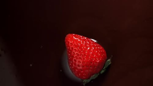 Strawberry Falls into Dark Chocolate in Slow Motion