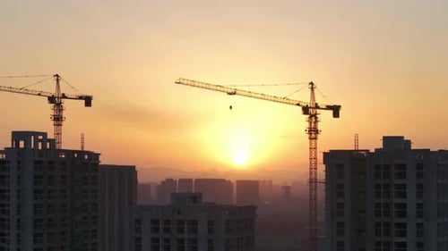 Cinematic And Majestic View Of Buildings Construction With Cranes