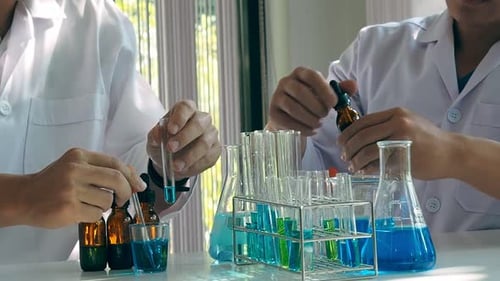 Scientists Conduct Chemistry Experiment in a Lab
