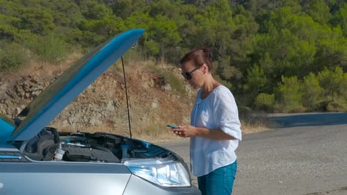 Woman Calling for Assistance Near Broken Car
