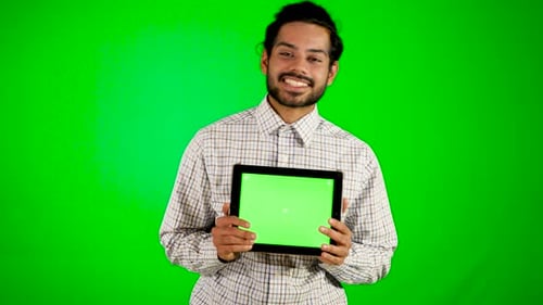 gars utilisant un mobile/une tablette avec écran vert et fond vert mec indien avec écran vert