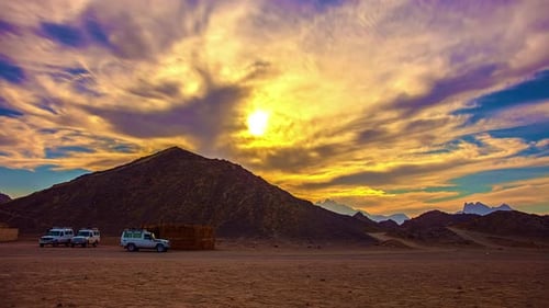 Sunset over a sandstone mountain in the Egyptian desert landscape - time lapse
