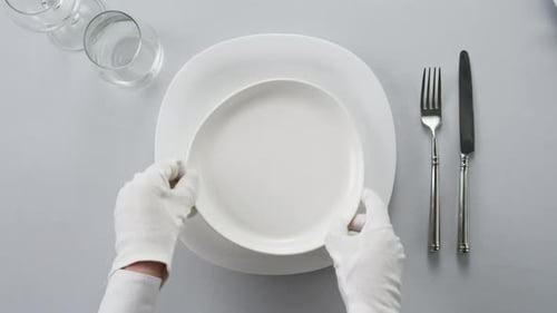Fancy Restaurant Waiter Elegant Table Setting with White Square Plate and Silverware Arranged for