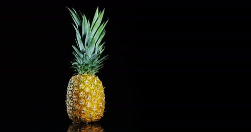 composition of three ripe and fresh pineapple, on elegant black background. Pineapple, exotic frui