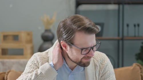 Man with Neck Pain Rubbing Sore Muscles