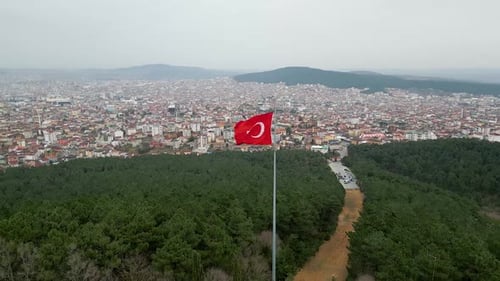 Turkish Flag Flies Over City and Forest Landscape