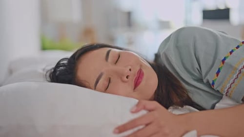 Young Adult Woman Sleeping Peacefully in Bed