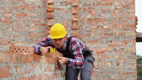 Worker Control Brick Wall Using Level Tool