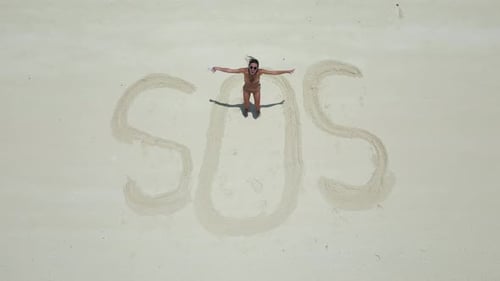 Woman Make Inscription on the Sand SOS Shoot From the Drone Wave for to Attract Attention