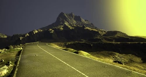 Majestic Mountain View Along a Winding Road at Dusk Under a Glowing Sky