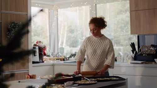 Woman Baking Christmas Cookies in Bright Kitchen