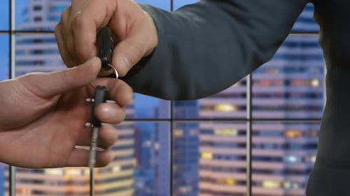 Male Hands Passing Car Key