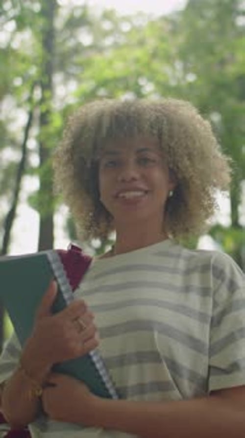 Portrait of Latin Female Student with Workbook in Park