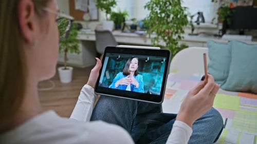 Woman Uses Tablet for Online Video Conference
