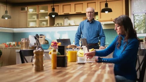 Senior Couple in the Kitchen with Orange Juice