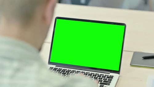Man Working on Laptop with Chroma Key Green Screen
