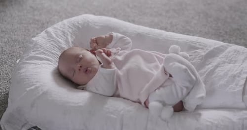 Sweet Infant Sleeping Peacefully in White Lounger