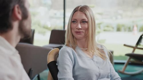 Smiling Couple Sitting in Modern Cafe Caucasian Girl and Guy Talk to Each Other Have Conversation