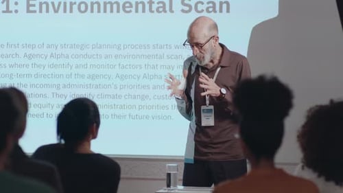 Senior Business Leader Holding Presentation on Corporate Seminar