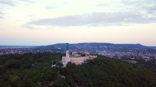 Budapest liberty statue and view of the early sun over the city