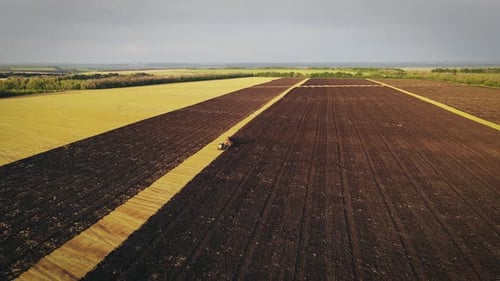 Plowing and Harrowing Agricultural Field Preparing Soil for Planting