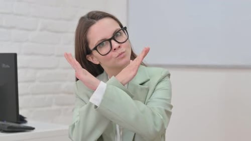 Woman Gesturing No in Office Environment