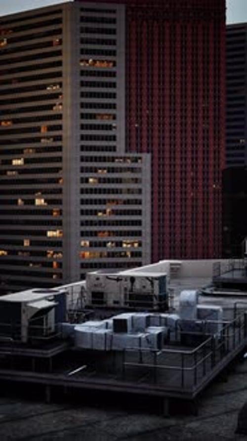 Modern Building With Many Windows By Parking Lot