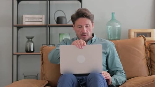 Middle Aged Man Closing Laptop and Leaving Room