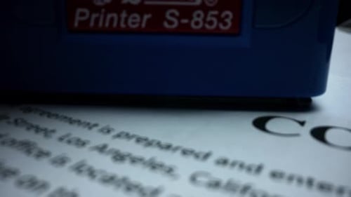 Macro Rubber Stamp Making Seal on Business Contract. Red Stamp With