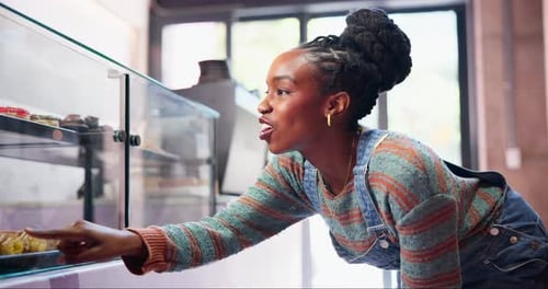 Bakery, counter and black woman with choice of pastry for happy customer in small business