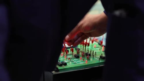 Two technicians assembling electronic equipment.