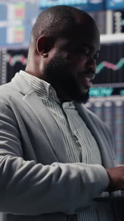Professional Man Types on Laptop in Front of Data