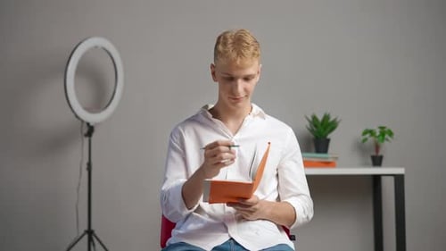 Man College Student Studying at Home Pov Sitting on Chair Listening Watching Lesson Online on