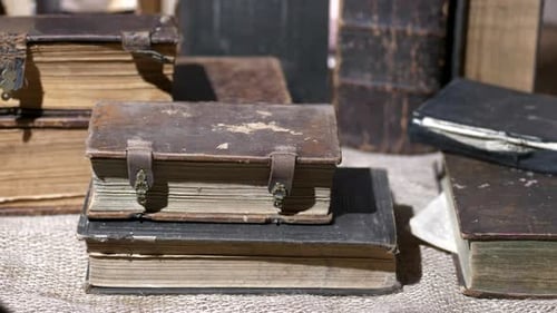 Antique Leather Books Stacked on Burlap
