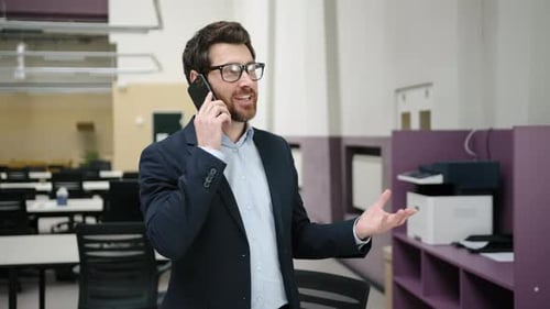 Closeup View of a Confident Businessman Using a Smartphone and Talking