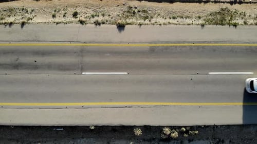 Road in the desert from above with cars driving, aerial view