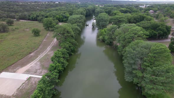 Aerial footage of the Medina River in Bandera Texas. Camera flies over ...
