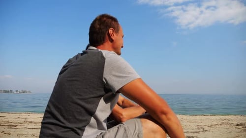 Happy Couple Hugs During Sitting on Wooden Log on Sandy Beach Romantic Man Kissing His Beloved Near
