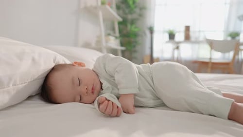 Infant Sleeping Soundly in a Bright Bedroom
