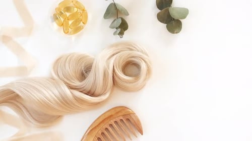 Blond Shiny Wavy Hair on White Background Shiny Woman Hair Strand Curl Hair Care and Beauty Salon