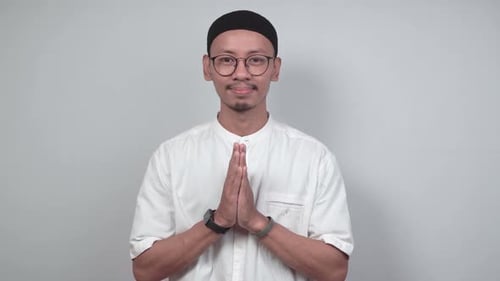 Asian Muslim man giving Eid al-Fitr greetings